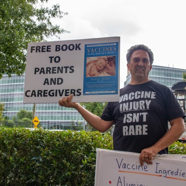Man protesting and educating about vaccine injuries